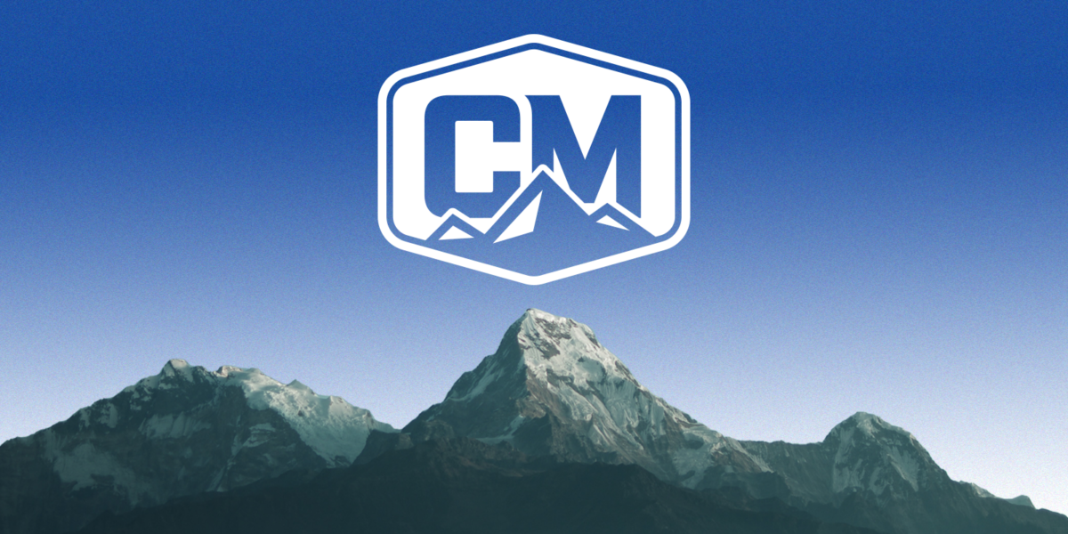 White CodeMettle logo on a blue sky above a realistic mountain range
